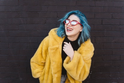 Young woman with blue hair, exhibiting Aries traits such as not being boring and ambition.